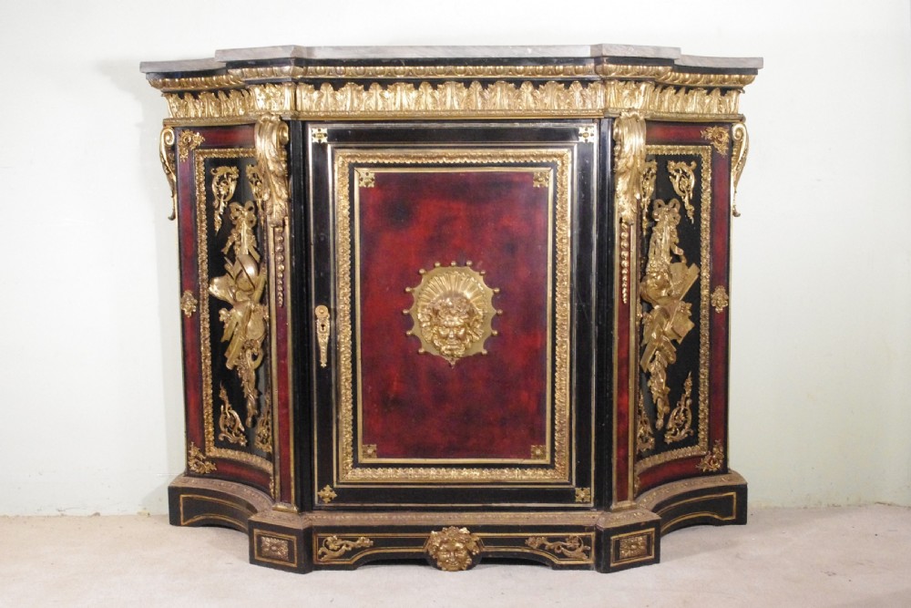 A 19th-century French ebonised side cabinet featuring gilt-metal mounts, a central red panel with a classical medallion, and a contoured marble top. View XXVIII