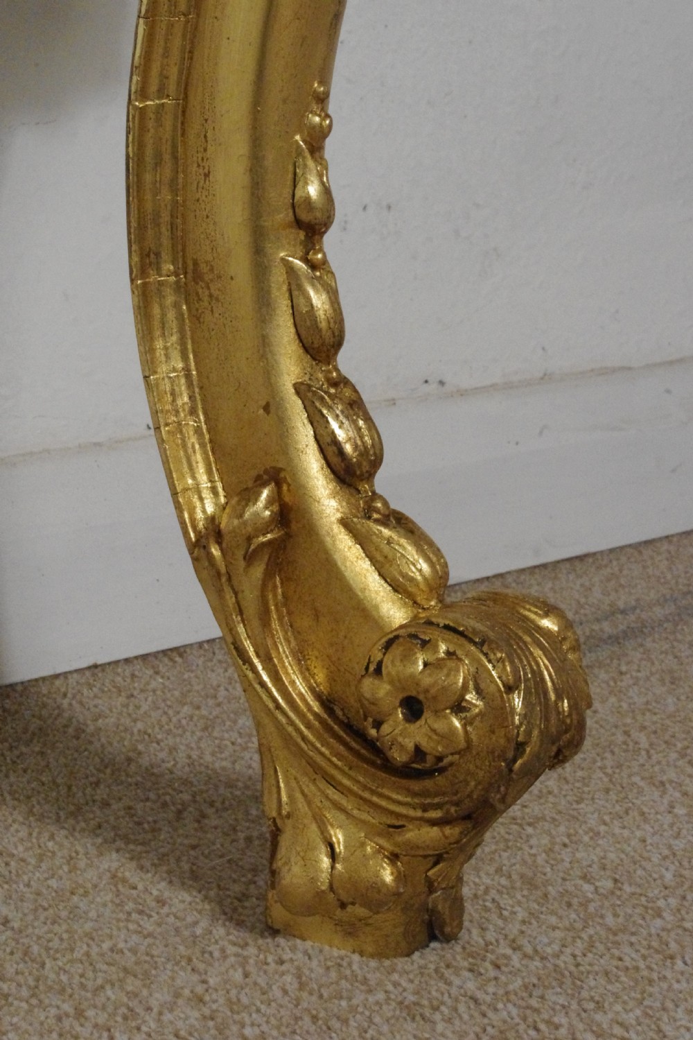 A 19th-century Rococo Revival giltwood console table featuring an ornate carved apron, cabriole legs, and a shaped white marble top. View XVII