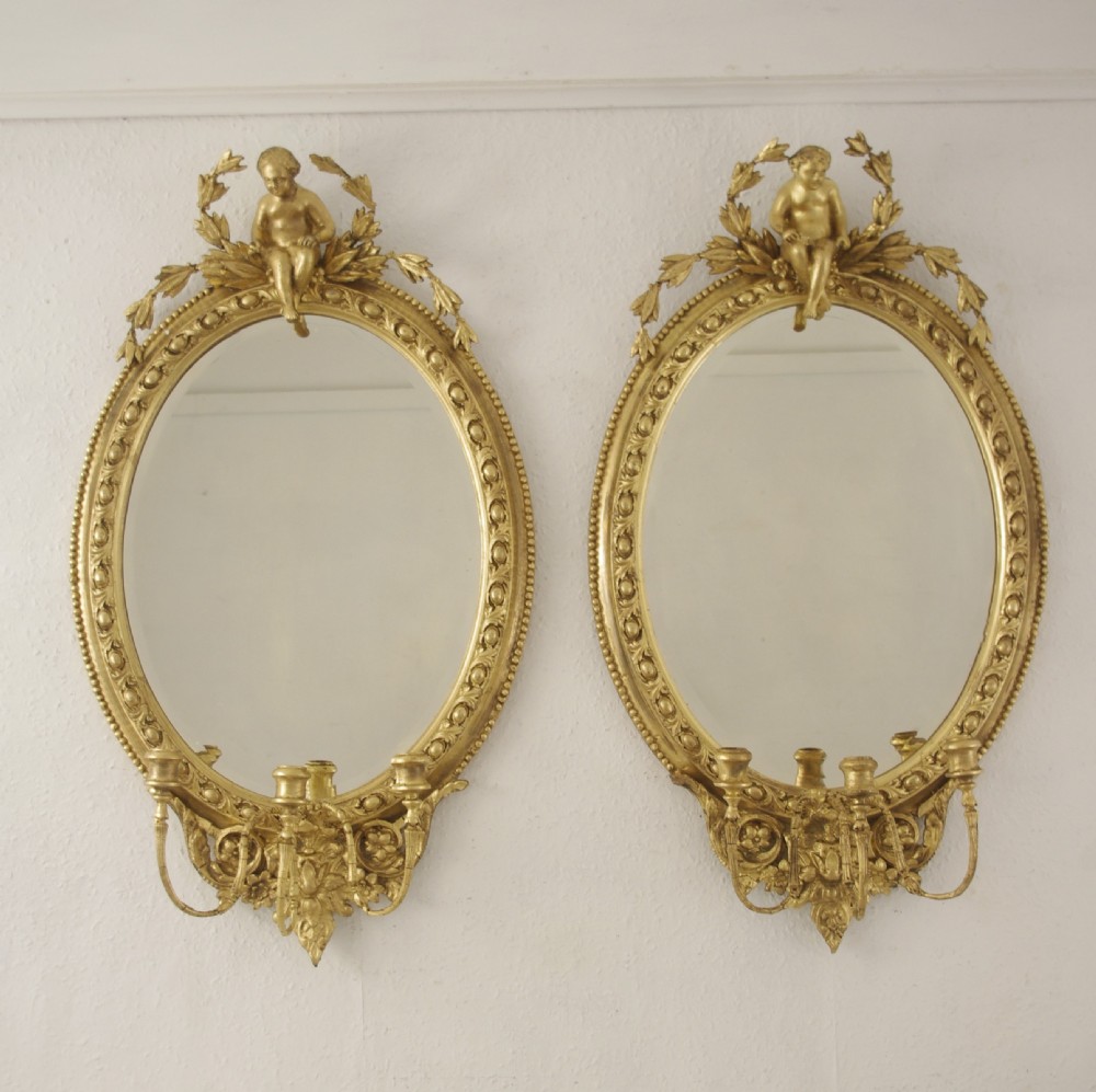 Pair of Victorian Gilt Oval Girandole  Mirrors with Putto Cresting