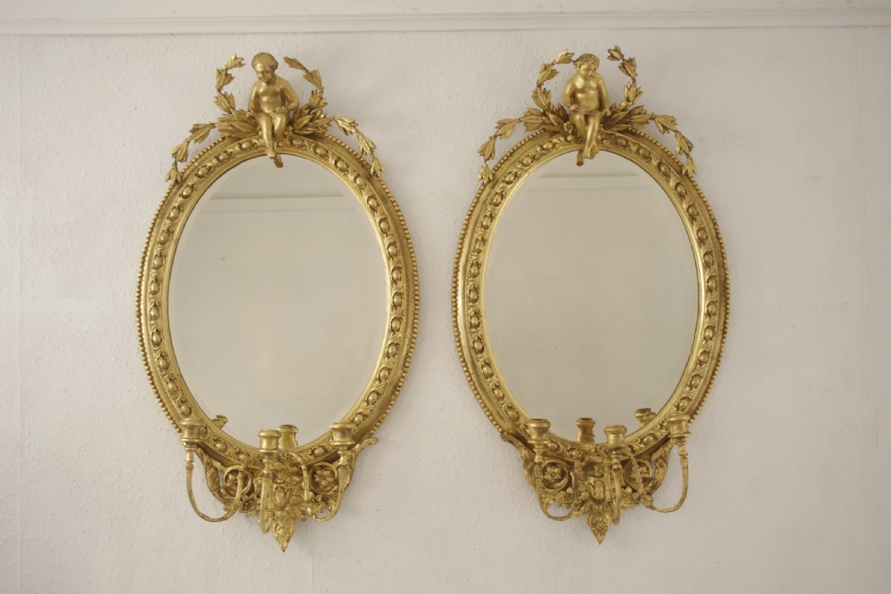 Pair of Victorian Gilt Oval Girandole  Mirrors with Putto Cresting View II