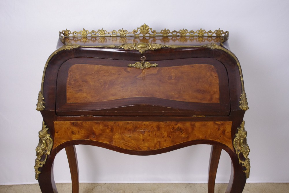 A French Louis XV style bureau de dame constructed from burr walnut veneer with cabriole legs and ornate gilt metal mounts. View III