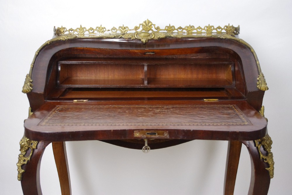 A French Louis XV style bureau de dame constructed from burr walnut veneer with cabriole legs and ornate gilt metal mounts. View IX