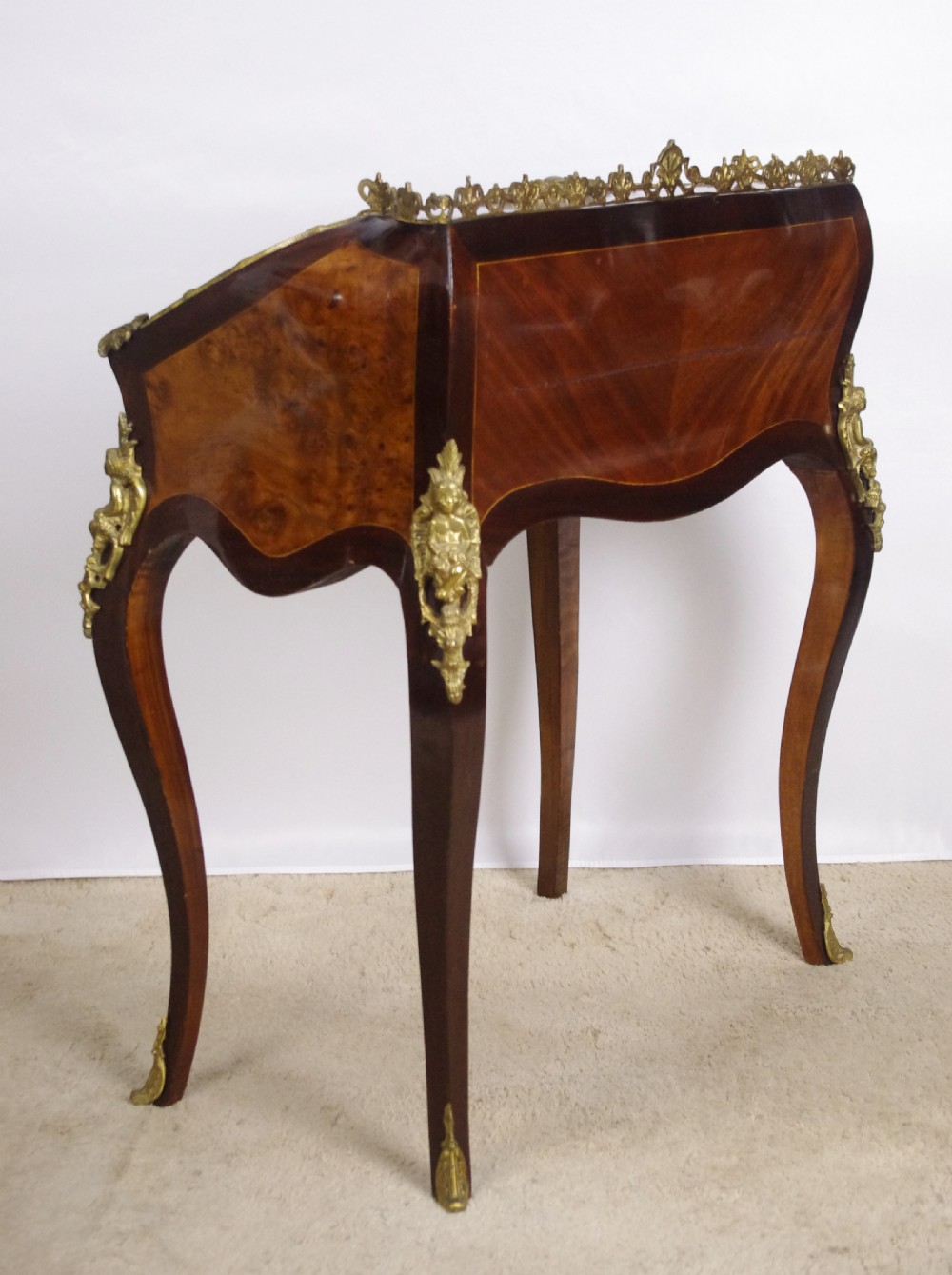 A French Louis XV style bureau de dame constructed from burr walnut veneer with cabriole legs and ornate gilt metal mounts. View XIII