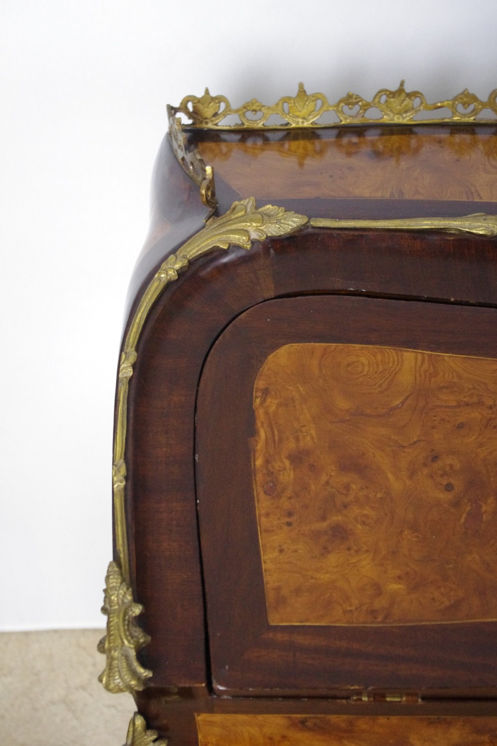 A French Louis XV style bureau de dame constructed from burr walnut veneer with cabriole legs and ornate gilt metal mounts. View XVII