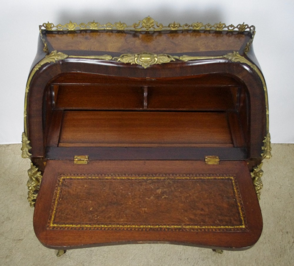 A French Louis XV style bureau de dame constructed from burr walnut veneer with cabriole legs and ornate gilt metal mounts. View XVIII