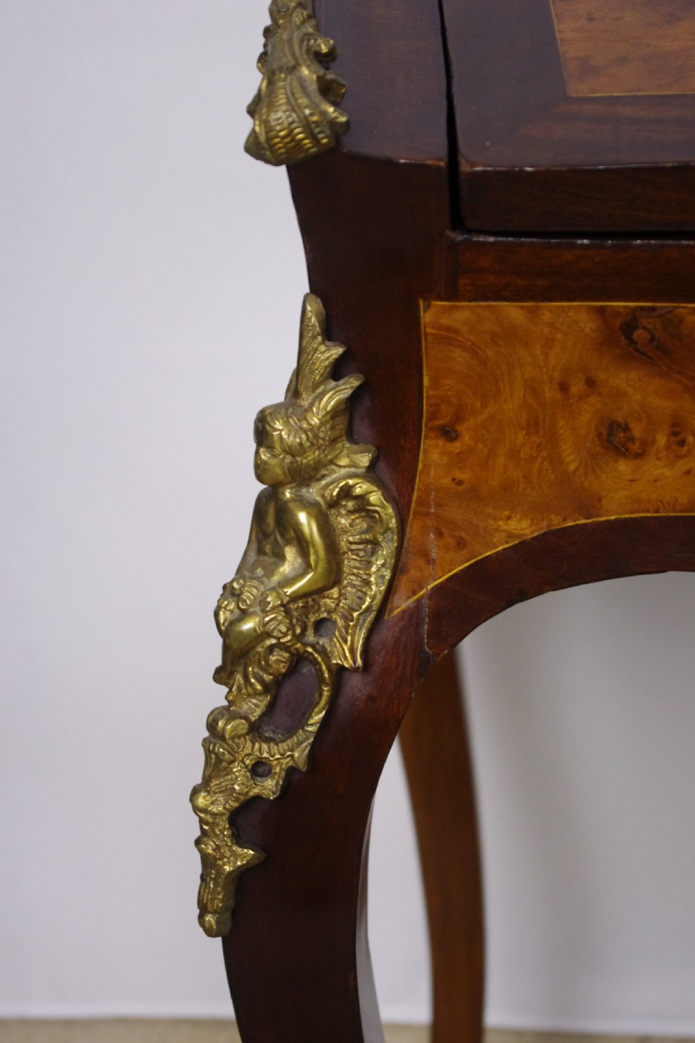 A French Louis XV style bureau de dame constructed from burr walnut veneer with cabriole legs and ornate gilt metal mounts. View XX