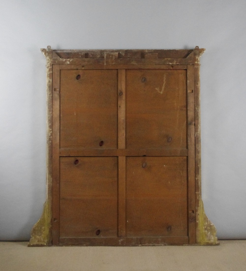 A large rectangular giltwood overmantel mirror in the Neoclassical style featuring fluted pilasters, classical frieze moulding, and decorative base scrolls. View VIII