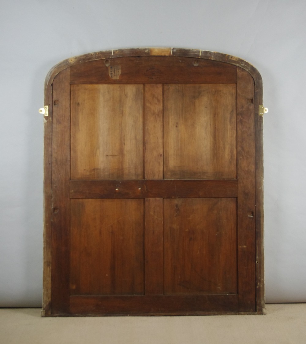 A large Victorian arched overmantel mirror featuring a gilded wooden frame decorated with detailed beadwork around the inner rim. View IX