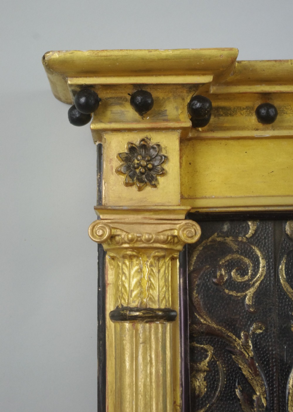 A tall rectangular Regency giltwood pier mirror featuring fluted pilasters, spherule cornice details, and a decorative foliate frieze panel above the glass. View IV