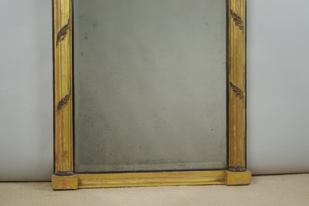 A tall rectangular Regency giltwood pier mirror featuring fluted pilasters, spherule cornice details, and a decorative foliate frieze panel above the glass. View VIII