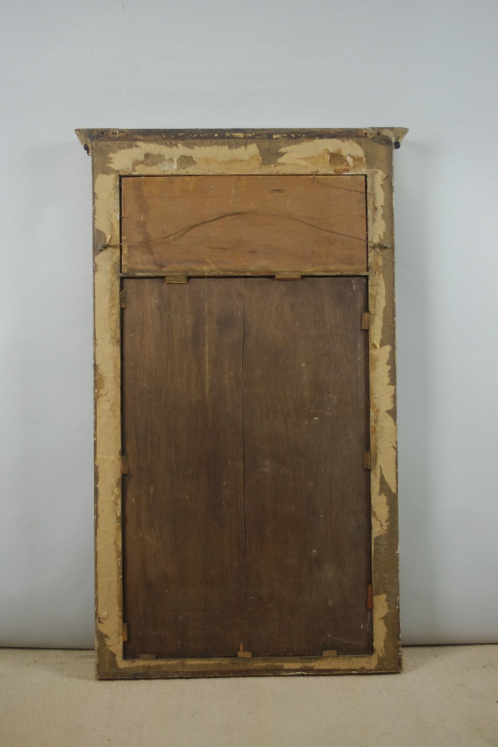 A tall rectangular Regency giltwood pier mirror featuring fluted pilasters, spherule cornice details, and a decorative foliate frieze panel above the glass. View IX