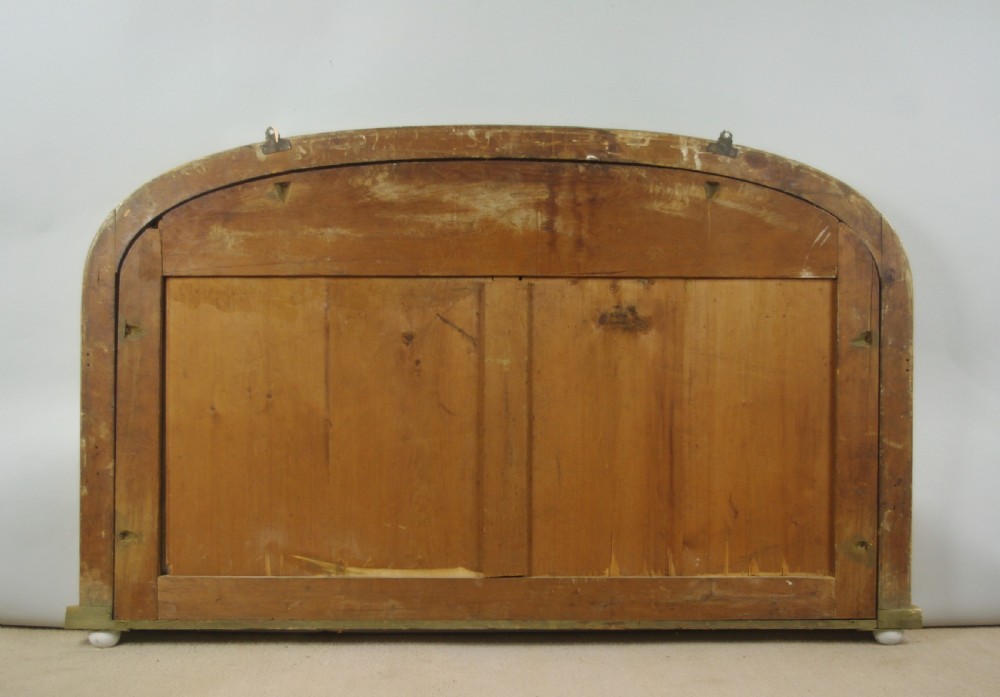 A Victorian arched overmantel mirror featuring a gilded frame with rope-twist detail and a flat base. View IX