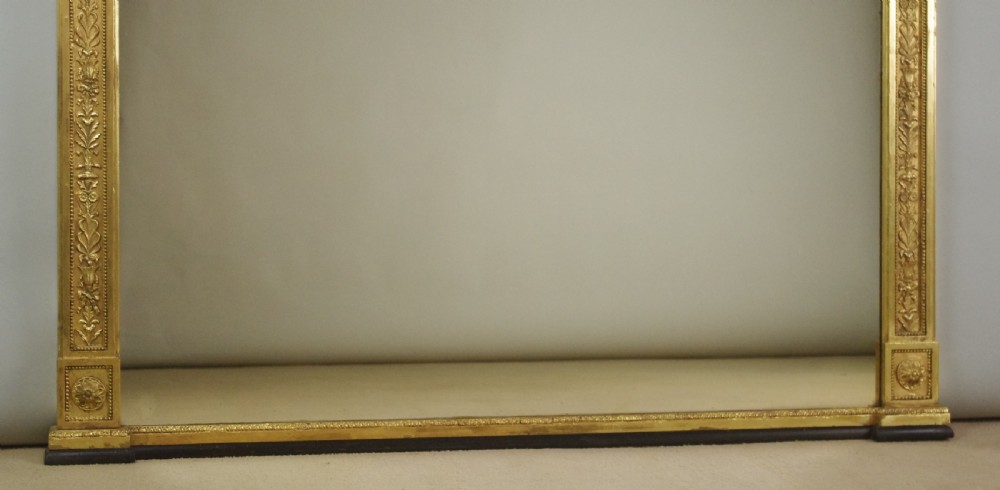 A large rectangular Victorian gilt overmantel mirror featuring Neoclassical swags, rosettes, and beaded moulding along the frame. View X