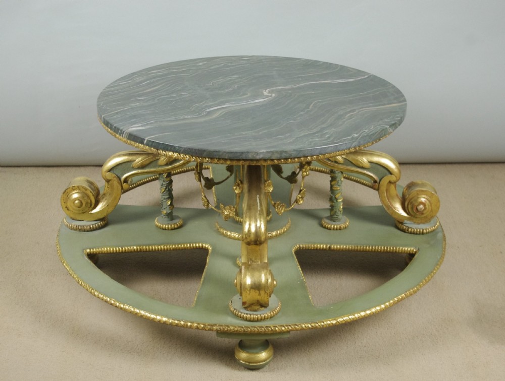 A low circular French Neoclassical style centre table featuring a dark green marble top and a sage green painted base with carved parcel-gilt scroll supports. View II