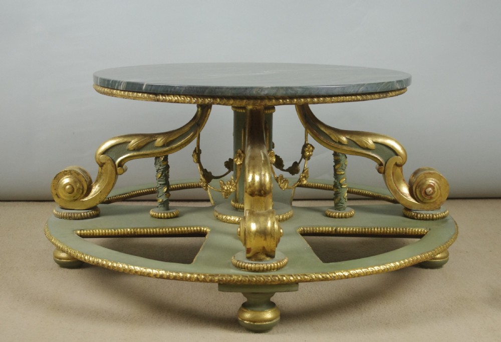 A low circular French Neoclassical style centre table featuring a dark green marble top and a sage green painted base with carved parcel-gilt scroll supports. View III