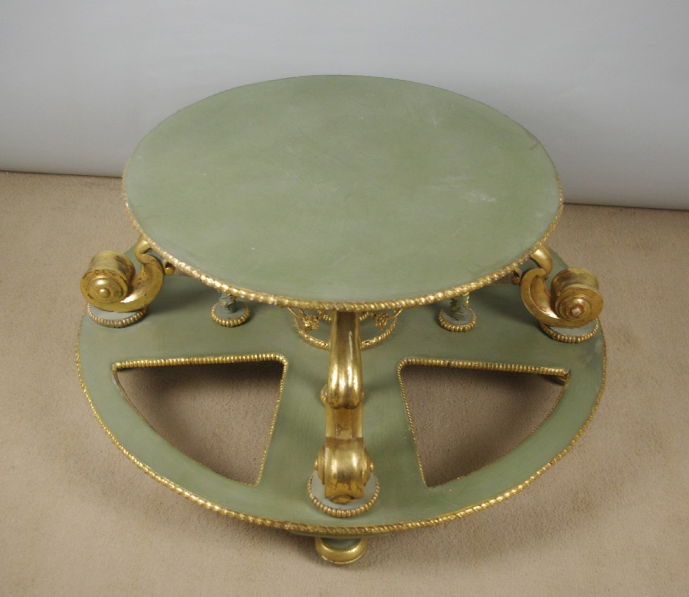 A low circular French Neoclassical style centre table featuring a dark green marble top and a sage green painted base with carved parcel-gilt scroll supports. View XII
