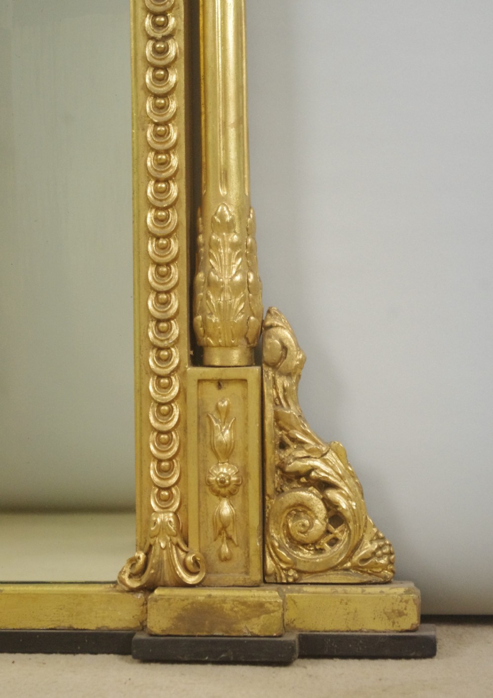A large Victorian gold gilded overmantel mirror featuring an ornate shell crest pediment and slender side columns. View VIII