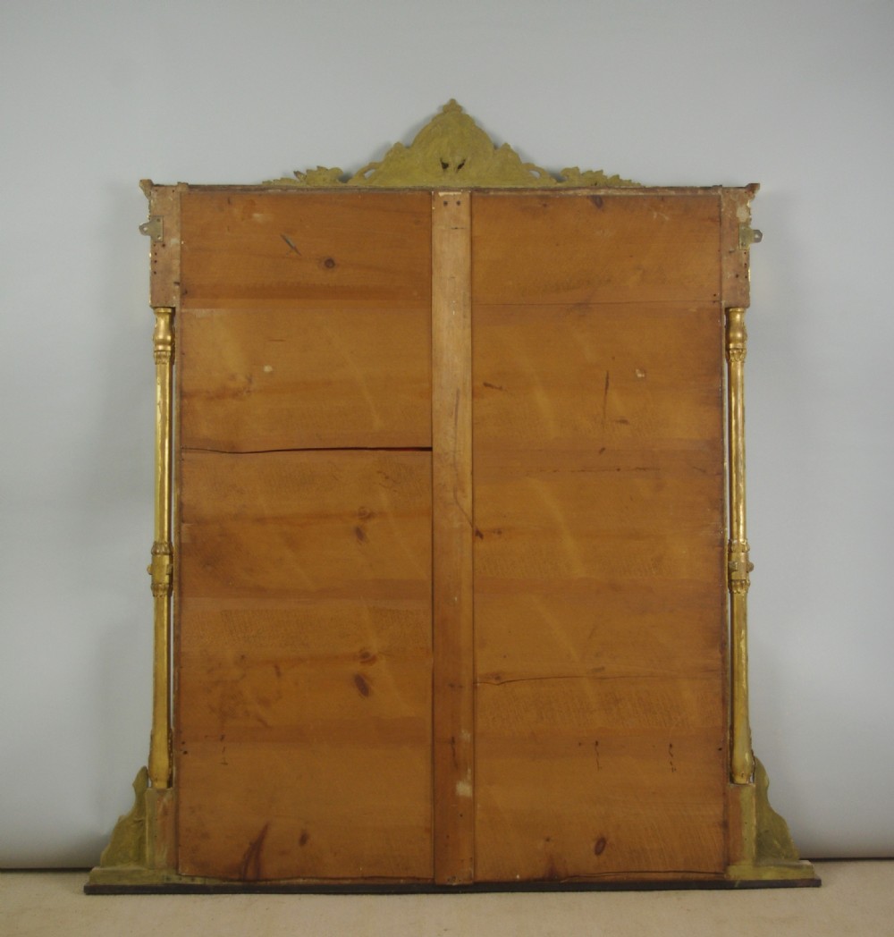 A large Victorian gold gilded overmantel mirror featuring an ornate shell crest pediment and slender side columns. View X