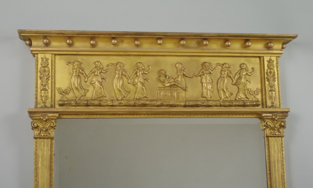 A rectangular Victorian giltwood overmantel mirror with a classical figure frieze and fluted side columns. View II