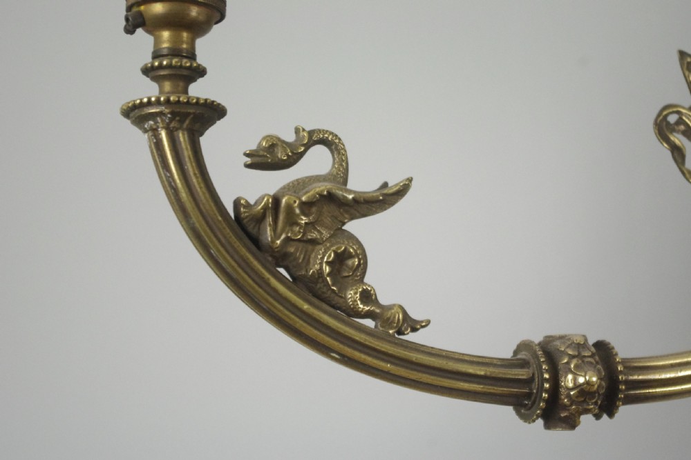 A pair of cast brass Victorian wall sconces featuring sculpted cherubs, mythological creature accents, and ornamental scroll arms. View XI
