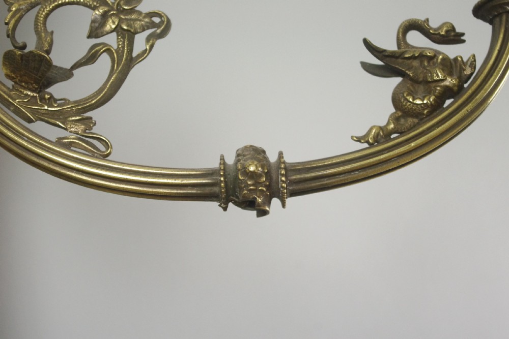 A pair of cast brass Victorian wall sconces featuring sculpted cherubs, mythological creature accents, and ornamental scroll arms. View XIII