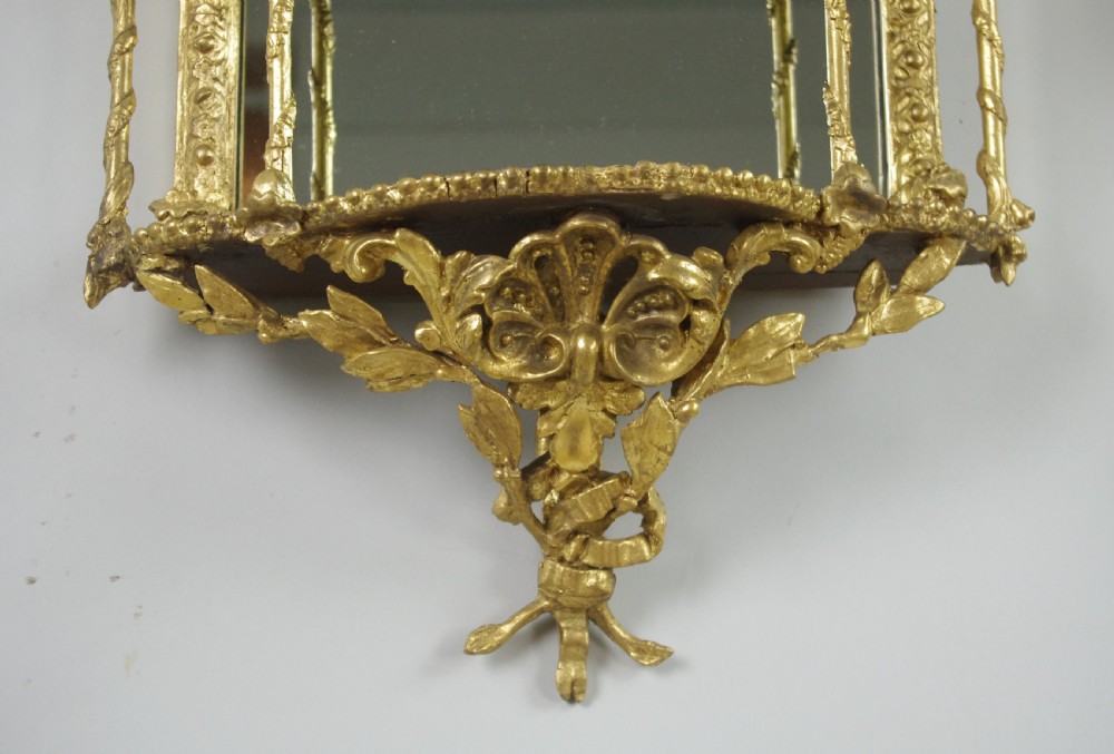 A matching pair of Victorian giltwood wall shelves featuring mirrored backs, ornate bow cresting, and open tiers for displaying small objects. View XI