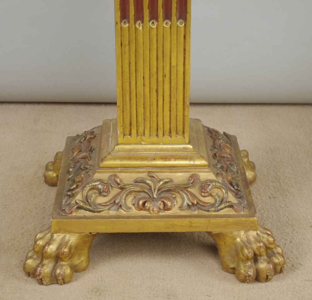 A square Victorian occasional table featuring a red veined marble top resting on a giltwood fluted pedestal with lion paw feet. View VII