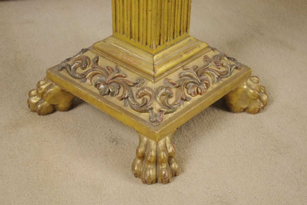 A square Victorian occasional table featuring a red veined marble top resting on a giltwood fluted pedestal with lion paw feet. View VIII