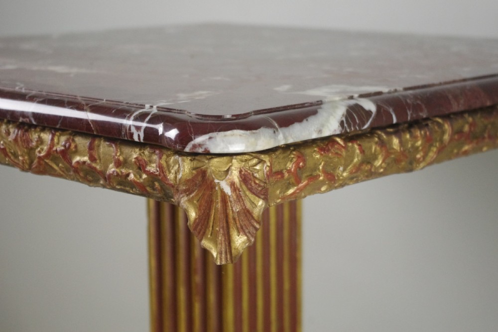 A square Victorian occasional table featuring a red veined marble top resting on a giltwood fluted pedestal with lion paw feet. View IX