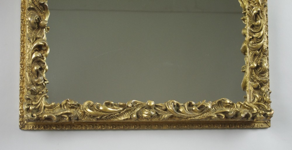 A rectangular Victorian wall mirror featuring an ornate gold giltwood frame with detailed scrollwork moulding. View V