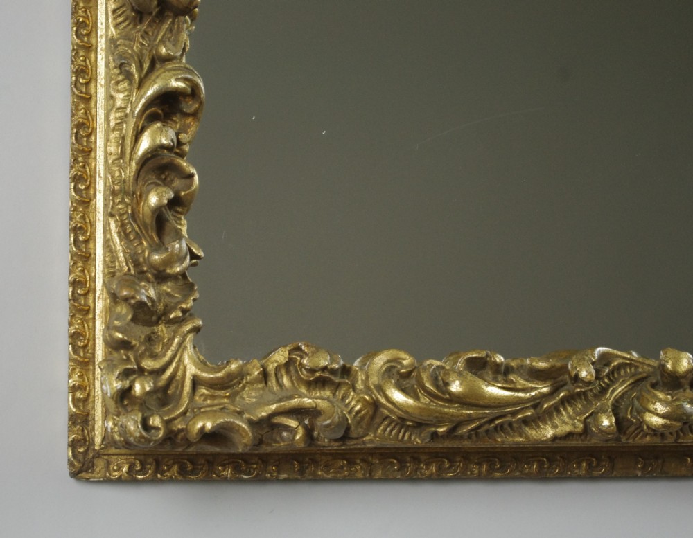 A rectangular Victorian wall mirror featuring an ornate gold giltwood frame with detailed scrollwork moulding. View IX