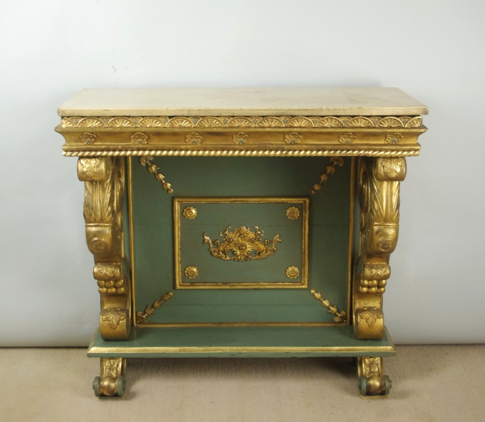 A 19th-century French console table with a cream marble top, green painted base, gilding, and large scroll legs. View III