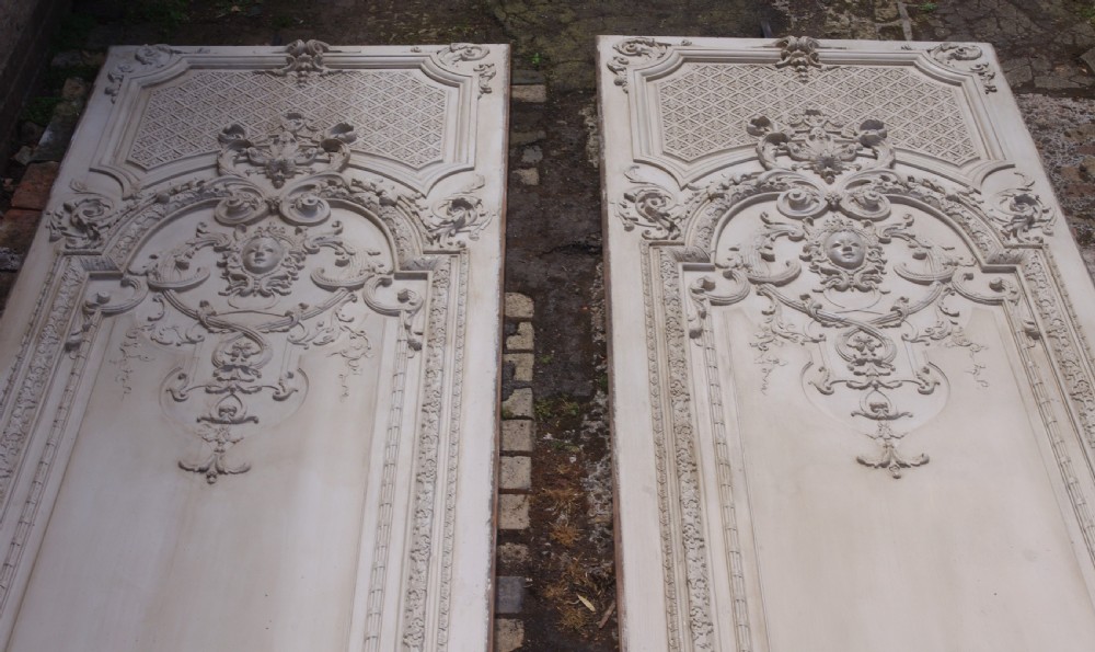 A pair of tall 19th-century French painted wood boiserie wall panels featuring intricate Rococo carved mouldings and foliage motifs in an off-white finish. View II