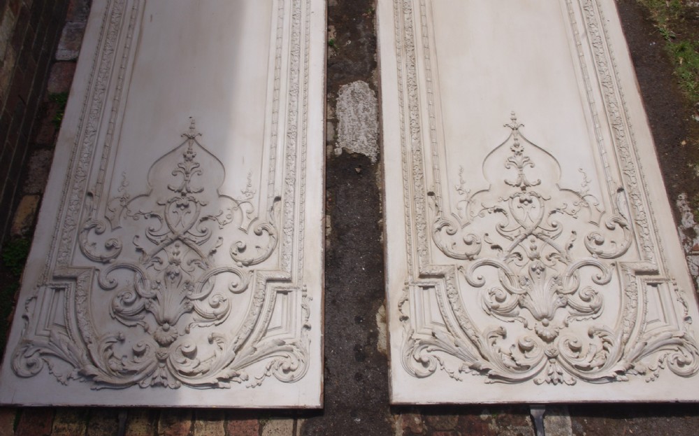 A pair of tall 19th-century French painted wood boiserie wall panels featuring intricate Rococo carved mouldings and foliage motifs in an off-white finish. View III