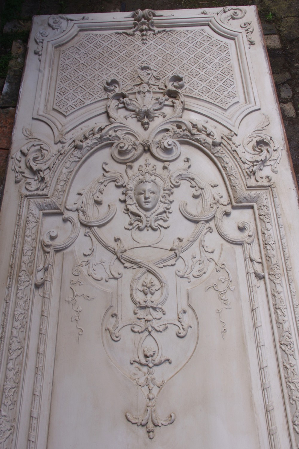 A pair of tall 19th-century French painted wood boiserie wall panels featuring intricate Rococo carved mouldings and foliage motifs in an off-white finish. View V