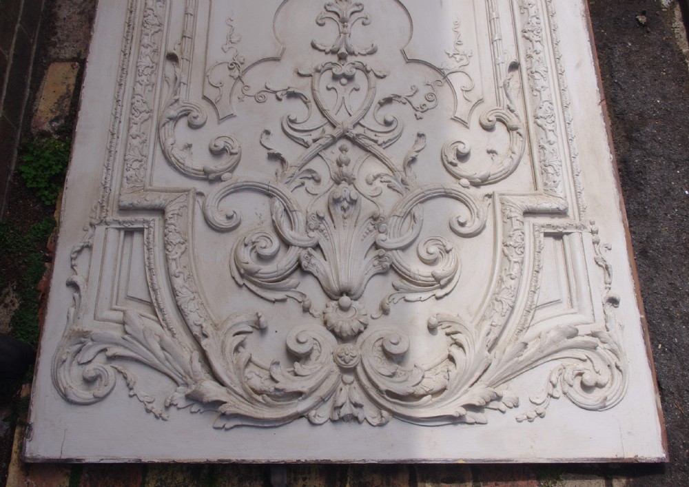 A pair of tall 19th-century French painted wood boiserie wall panels featuring intricate Rococo carved mouldings and foliage motifs in an off-white finish. View VII