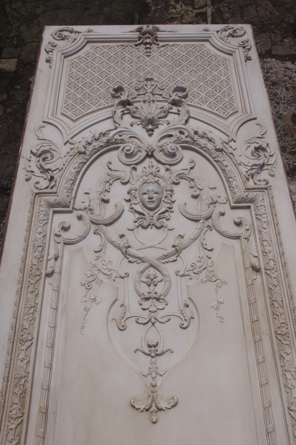 A pair of tall 19th-century French painted wood boiserie wall panels featuring intricate Rococo carved mouldings and foliage motifs in an off-white finish. View X