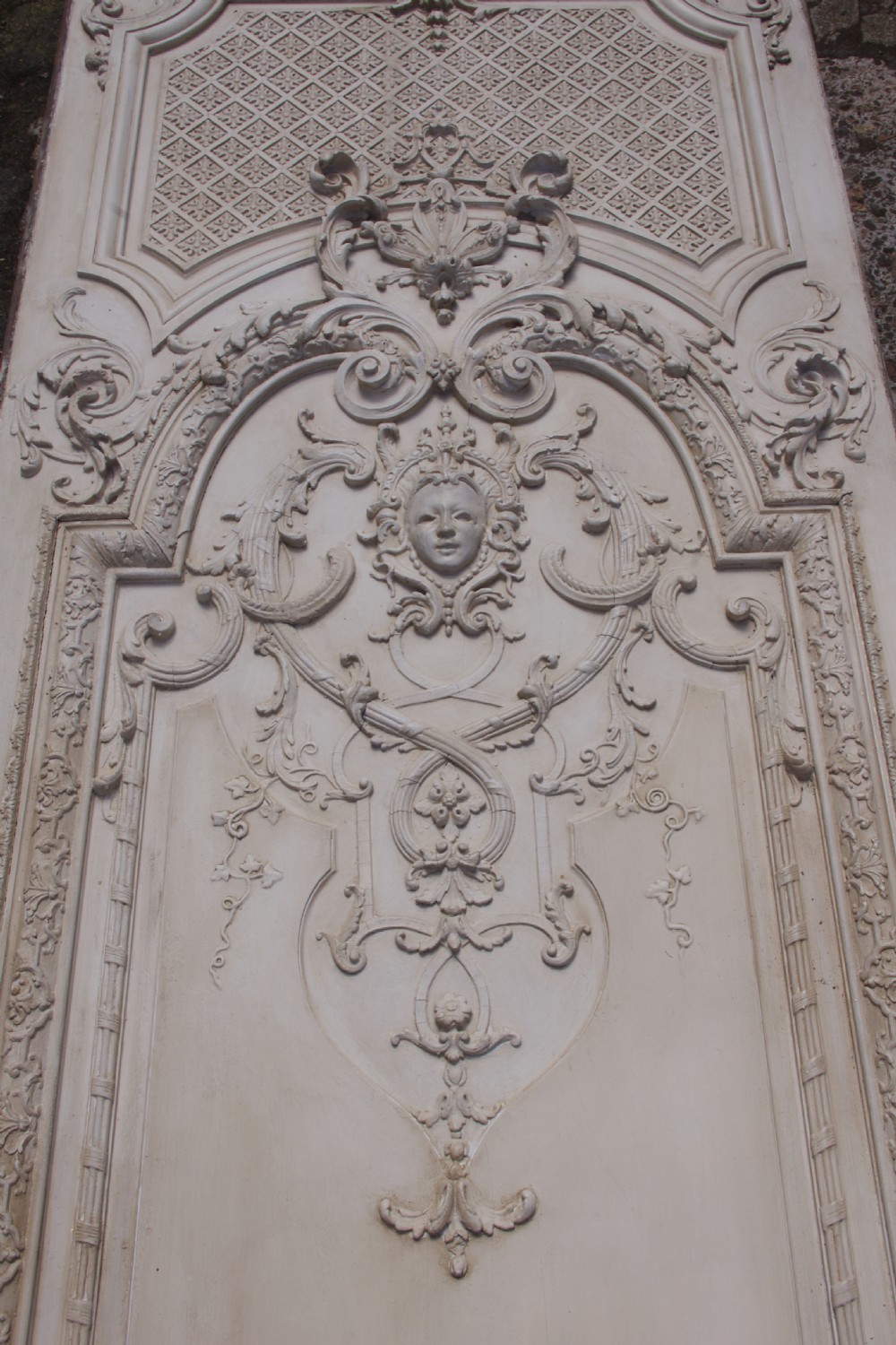 A pair of tall 19th-century French painted wood boiserie wall panels featuring intricate Rococo carved mouldings and foliage motifs in an off-white finish. View XI