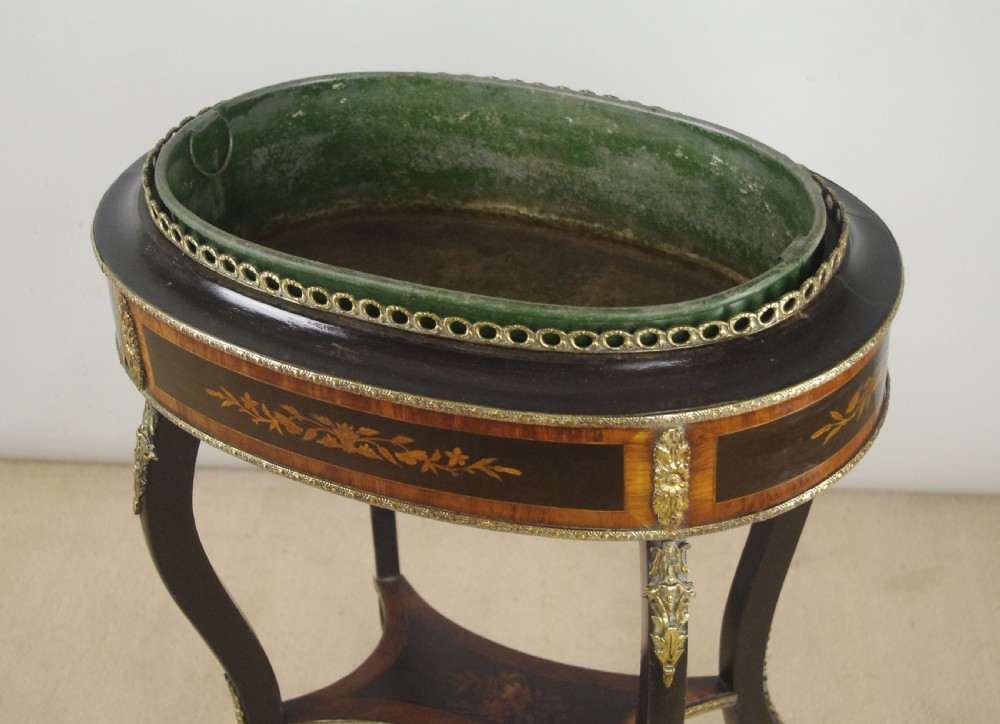 A 19th-century French oval ebonised jardiniere table featuring floral marquetry frieze, gilt-bronze mounts, cabriole legs, and a green metal liner with a pierced brass gallery. View VII