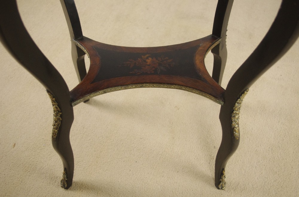 A 19th-century French oval ebonised jardiniere table featuring floral marquetry frieze, gilt-bronze mounts, cabriole legs, and a green metal liner with a pierced brass gallery. View IX