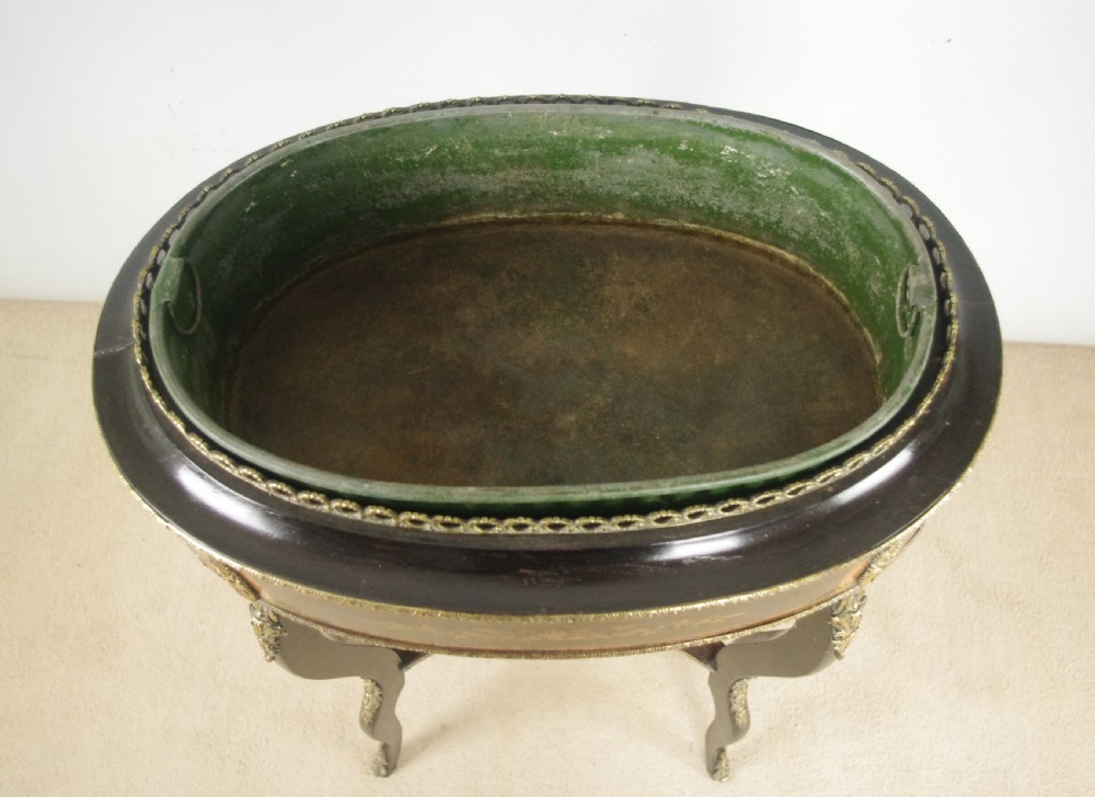 A 19th-century French oval ebonised jardiniere table featuring floral marquetry frieze, gilt-bronze mounts, cabriole legs, and a green metal liner with a pierced brass gallery. View XI