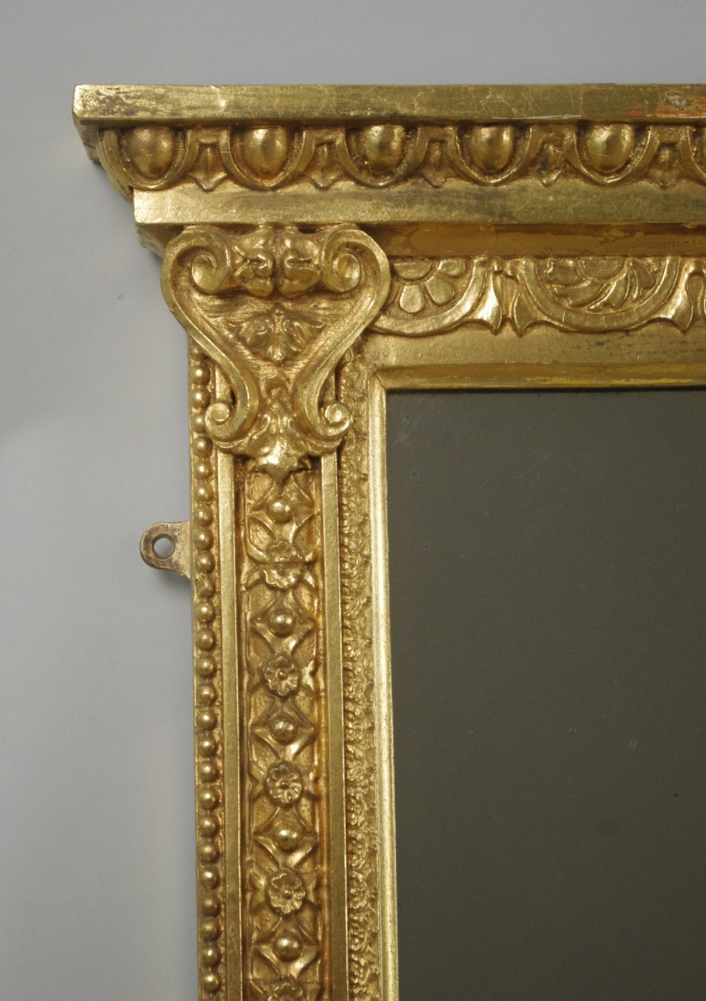 A wide rectangular Victorian overmantel mirror featuring a gilded frame with egg-and-dart moulding and detailed side pilasters. View IV