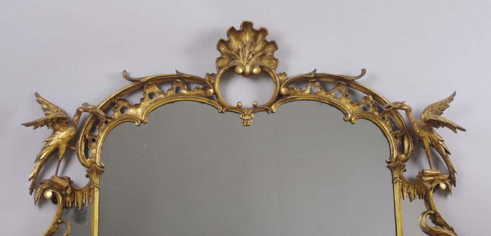 A 19th-century Chinese Chippendale style giltwood overmantel mirror featuring pierced rococo scrollwork, acanthus cresting, and carved exotic birds flanking the central glass. View IV
