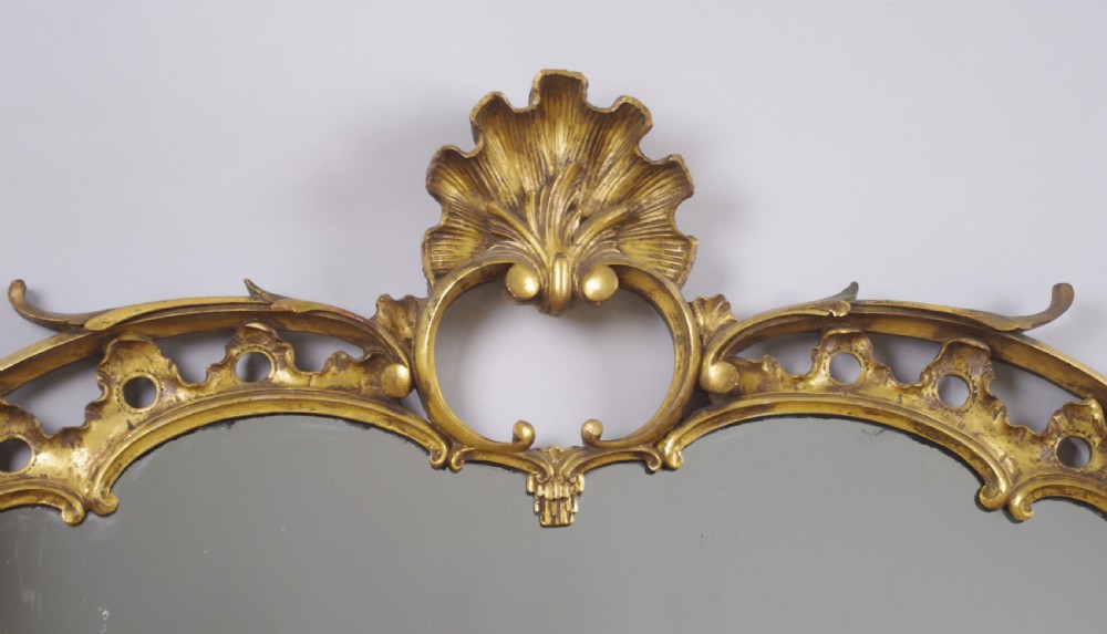 A 19th-century Chinese Chippendale style giltwood overmantel mirror featuring pierced rococo scrollwork, acanthus cresting, and carved exotic birds flanking the central glass. View VI