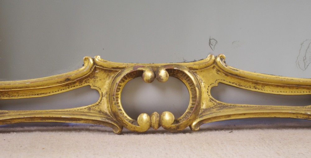 A 19th-century Chinese Chippendale style giltwood overmantel mirror featuring pierced rococo scrollwork, acanthus cresting, and carved exotic birds flanking the central glass. View XI