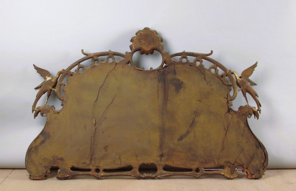 A 19th-century Chinese Chippendale style giltwood overmantel mirror featuring pierced rococo scrollwork, acanthus cresting, and carved exotic birds flanking the central glass. View XII