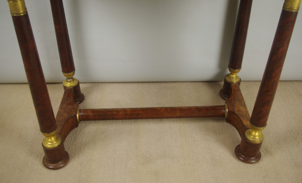 A French Empire mahogany dressing table featuring an oval swivel mirror flanked by gilt-bronze capped columns, set above a marble surface and drawer base with ormolu appliques. View XVI