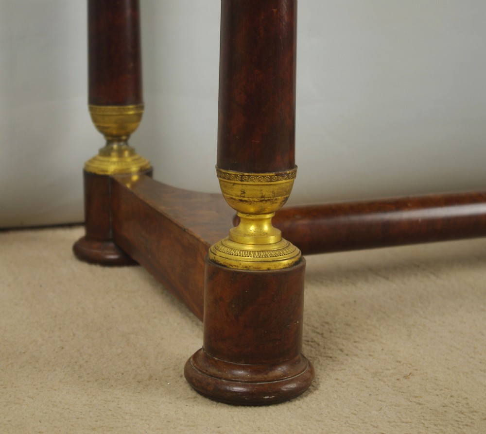 A French Empire mahogany dressing table featuring an oval swivel mirror flanked by gilt-bronze capped columns, set above a marble surface and drawer base with ormolu appliques. View XVII