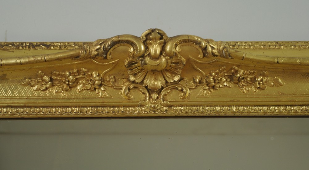 A large rectangular Victorian giltwood wall mirror featuring an ornate swept frame with shell and scroll corner mouldings. View X