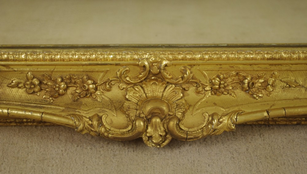 A large rectangular Victorian giltwood wall mirror featuring an ornate swept frame with shell and scroll corner mouldings. View XI